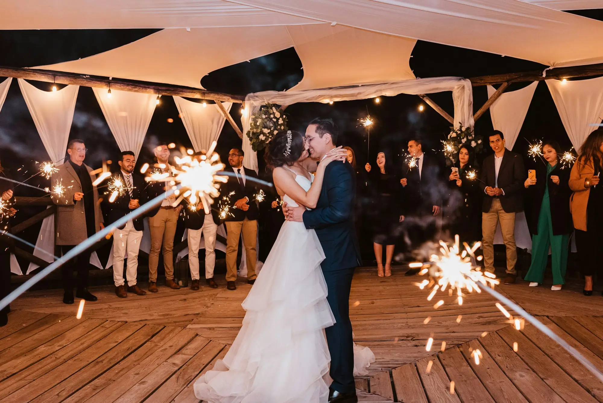 Pareja de novios bailando entre luces de bengala
